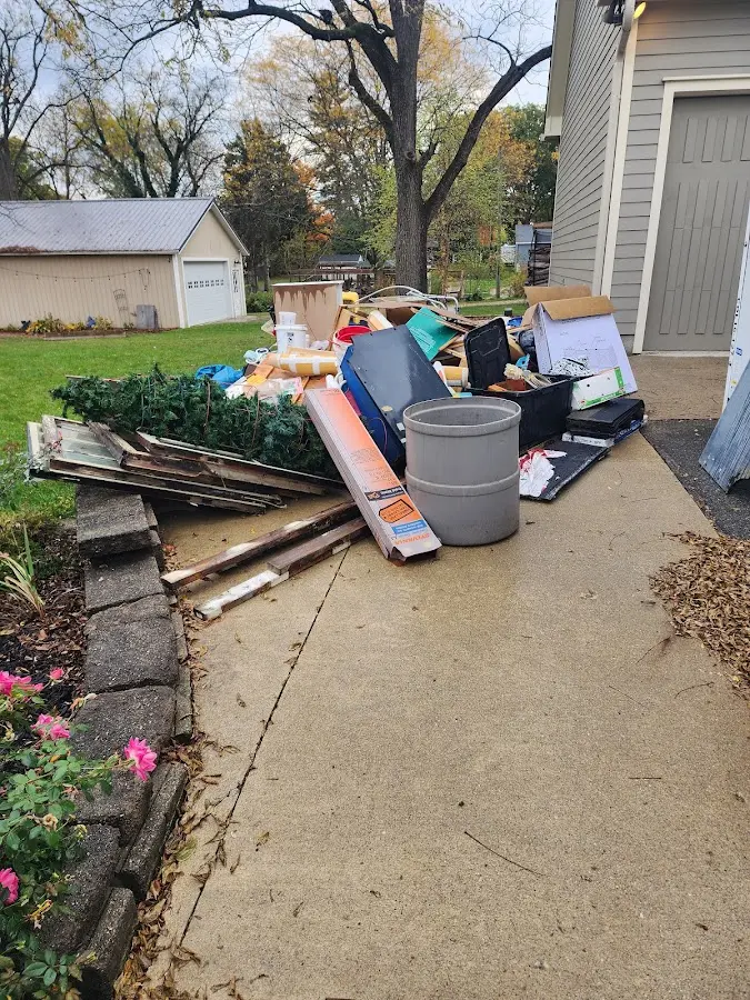 Dumpster being loaded with debris for Estate Cleanout Dumpster Rental in Bell